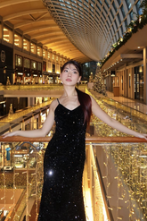 a lady in a black sequin velvet dress